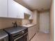 Functional laundry room with modern washer and dryer, white cabinetry, and a convenient utility sink at 14296 Pullman Dr, Spring Hill, FL 34609