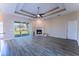 Bright living room with ceiling fan, fireplace, and sliding glass door to the backyard at 14296 Pullman Dr, Spring Hill, FL 34609