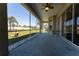 Screened-in patio with a view of the backyard, landscaping and table with chairs at 14296 Pullman Dr, Spring Hill, FL 34609