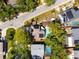 Aerial view of the property with a backyard pool, wooden deck, mature trees, and clearly marked boundaries at 14323 83Rd Pl, Seminole, FL 33776