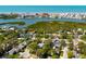 Breathtaking aerial view of neighborhood homes near the bay with coastal city skyline and white sand beach at 14323 83Rd Pl, Seminole, FL 33776