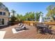 A backyard deck with lounge chairs, dining table, and hot tub at 14323 83Rd Pl, Seminole, FL 33776