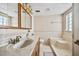Cozy bathroom featuring a bathtub, single sink vanity, and neutral tiling at 14323 83Rd Pl, Seminole, FL 33776