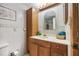 Bathroom with a single sink vanity, tile backsplash, and a storage cabinet at 14323 83Rd Pl, Seminole, FL 33776