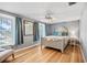 Relaxing bedroom with hardwood floors, gray walls, and natural light from the windows at 14323 83Rd Pl, Seminole, FL 33776
