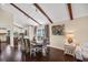 Formal dining room featuring a wood floor, decorative beams, and updated light fixtures at 14323 83Rd Pl, Seminole, FL 33776