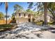Captivating exterior of a two-story home featuring a driveway, two-car garage, and mature landscaping at 14323 83Rd Pl, Seminole, FL 33776