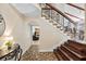 Elegant foyer with tile flooring and an ornate staircase, showcasing open archways at 14323 83Rd Pl, Seminole, FL 33776