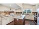 Bright and spacious kitchen with an island, granite countertops and stainless steel appliances at 14323 83Rd Pl, Seminole, FL 33776