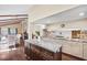 Kitchen with island featuring granite countertops, dark cabinets, and access to other living areas at 14323 83Rd Pl, Seminole, FL 33776
