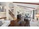 Open-concept living area with hardwood floors, dining area, and staircase with iron railings at 14323 83Rd Pl, Seminole, FL 33776