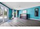 Living room features wood floors, blue walls and access to outdoor deck at 14323 83Rd Pl, Seminole, FL 33776