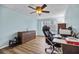 Home office with a ceiling fan, hardwood floors, and a large desk with a comfortable chair at 14323 83Rd Pl, Seminole, FL 33776