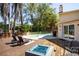 Pool with deck, fire pit, lounge chairs and grill at 14323 83Rd Pl, Seminole, FL 33776