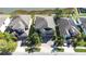 Aerial view of a home featuring a two-car garage, brick driveway, and manicured lawn in a residential area at 1564 Imperial Key Dr, Trinity, FL 34655