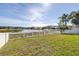The backyard has a pristine white fence with beautiful views of the lake at 1564 Imperial Key Dr, Trinity, FL 34655