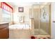 This bathroom features a garden tub with separate glass shower at 1564 Imperial Key Dr, Trinity, FL 34655