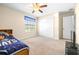 Bright bedroom offers a ceiling fan and neutral walls with large closet at 1564 Imperial Key Dr, Trinity, FL 34655