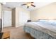 Carpeted bedroom with ceiling fan, walk-in closet and neutral walls at 1564 Imperial Key Dr, Trinity, FL 34655