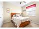 Comfortable bedroom featuring carpet flooring, a large window, and a queen-size bed with warm bedding at 1564 Imperial Key Dr, Trinity, FL 34655