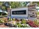 Community entrance sign for 'The Estates', set in a decorative stone and stucco structure with floral landscaping at 1564 Imperial Key Dr, Trinity, FL 34655