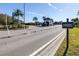 View of the resident entrance to a gated community, featuring a guard house and well-manicured landscaping at 1564 Imperial Key Dr, Trinity, FL 34655