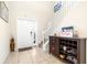 Inviting foyer with neutral walls, decorative furniture, and a view of the staircase at 1564 Imperial Key Dr, Trinity, FL 34655