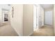 Neutral-toned hallway with carpeted floors, leading to multiple rooms and featuring Gathering photos at 1564 Imperial Key Dr, Trinity, FL 34655