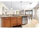 Kitchen with stainless appliances, wood cabinets, tile floors, and stone countertops at 1564 Imperial Key Dr, Trinity, FL 34655