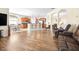 Open-concept living space with wood floors connecting kitchen, dining, and living areas for easy gathering at 1564 Imperial Key Dr, Trinity, FL 34655