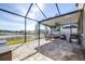 Spacious screened patio features ample seating and stunning views of the tranquil lake at 1564 Imperial Key Dr, Trinity, FL 34655