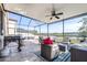 Inviting screened-in patio with a grill and comfortable seating overlooking the peaceful lake at 1564 Imperial Key Dr, Trinity, FL 34655