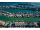 Wide aerial view of waterfront homes with docks, a bay, and cityscape with a bridge in the background on a sunny day at 161 Brightwater Dr # 8, Clearwater Beach, FL 33767
