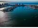 Panoramic aerial view of a marina filled with boats, set against a backdrop of open ocean and a clear blue sky at 161 Brightwater Dr # 8, Clearwater Beach, FL 33767