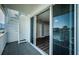 Outdoor balcony with spiral staircase and view through sliding glass doors to the bedroom at 161 Brightwater Dr # 8, Clearwater Beach, FL 33767