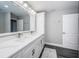 Bathroom features an extended double sink vanity with cabinets for storage, a large mirror, and gray walls at 161 Brightwater Dr # 8, Clearwater Beach, FL 33767
