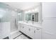 This bathroom features a double sink vanity, walk-in shower with glass door, and updated fixtures at 161 Brightwater Dr # 8, Clearwater Beach, FL 33767