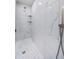 A glass enclosed shower features a built-in seat, elegant tile, shelving, and modern fixtures at 161 Brightwater Dr # 8, Clearwater Beach, FL 33767