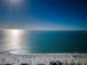 Expansive aerial view of a pristine beach, blue ocean, and clear sky on a sunny day at 161 Brightwater Dr # 8, Clearwater Beach, FL 33767