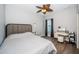 Bedroom features wood floors, large bed, ceiling fan, and vanity at 161 Brightwater Dr # 8, Clearwater Beach, FL 33767