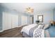 Spacious bedroom featuring stylish decor, ample closet space, and a ceiling fan at 161 Brightwater Dr # 8, Clearwater Beach, FL 33767