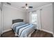 Cozy bedroom features a ceiling fan, wood floors, and a bright window view at 161 Brightwater Dr # 8, Clearwater Beach, FL 33767