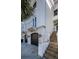Modern townhome featuring a private garage, balcony, and a white stucco facade for stylish curb appeal at 161 Brightwater Dr # 8, Clearwater Beach, FL 33767