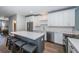 Kitchen boasting a large island, stainless steel appliances, white cabinets, and stylish backsplash at 161 Brightwater Dr # 8, Clearwater Beach, FL 33767