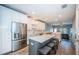 Open kitchen featuring an island with bar seating, stainless steel appliances, and modern white cabinets at 161 Brightwater Dr # 8, Clearwater Beach, FL 33767