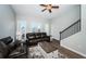 Bright living room featuring balcony access, ceiling fan, and inviting leather sofa seating at 161 Brightwater Dr # 8, Clearwater Beach, FL 33767