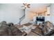 Open concept living room with fan, dark wood-look floors, and staircase to second story at 161 Brightwater Dr # 8, Clearwater Beach, FL 33767