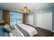 Light-filled bedroom with balcony access, waterfront view, large closet, and ceiling fan at 161 Brightwater Dr # 8, Clearwater Beach, FL 33767