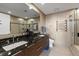 Elegant bathroom with dual sinks, a granite countertop, and a glass-enclosed shower at 175 1St S St # 3008, St Petersburg, FL 33701