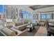 Contemporary living space with floor-to-ceiling windows offering a blend of city and bay views and chic bar area at 175 1St S St # 3008, St Petersburg, FL 33701